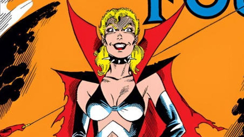 Malice standing in front of fire with her mask off