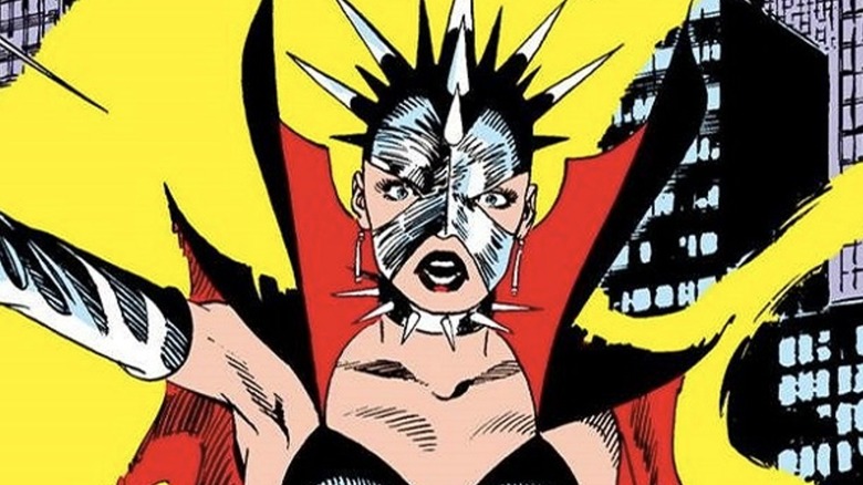 Malice wearing spiked mask and collar