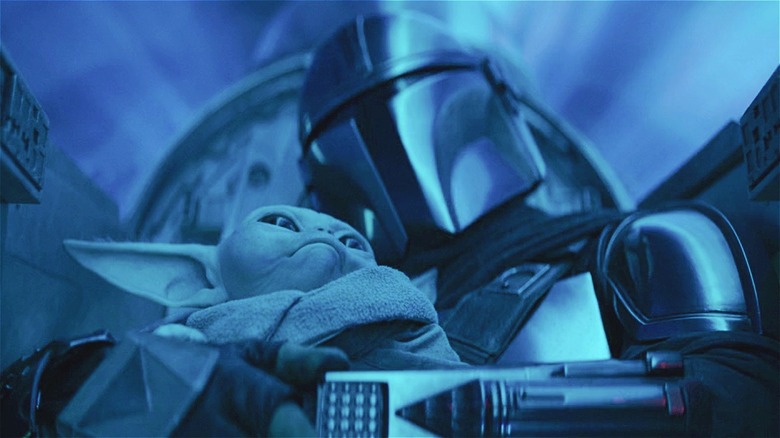 Grogu snuggles up to Mando in a Naboo Starfighter 