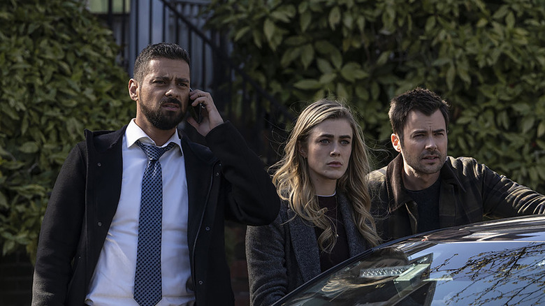 Michaela, Zeke, and Detective Vasquez standing by a car