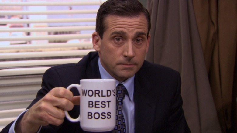 Michael Scott holding up his mug