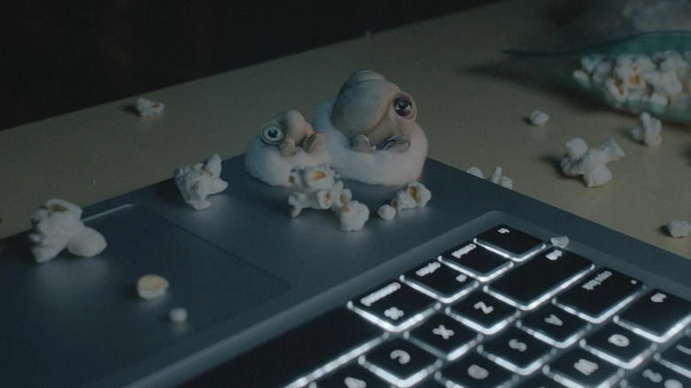 Marcel and Connie sit on laptop with popcorn