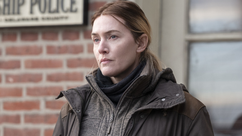 Mare looking serious outside in "Mare of Easttown" (2021)