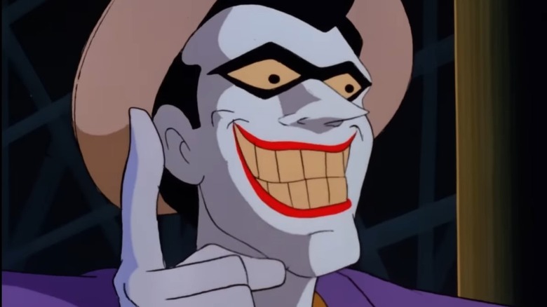 The Joker smiling and pointing a finger