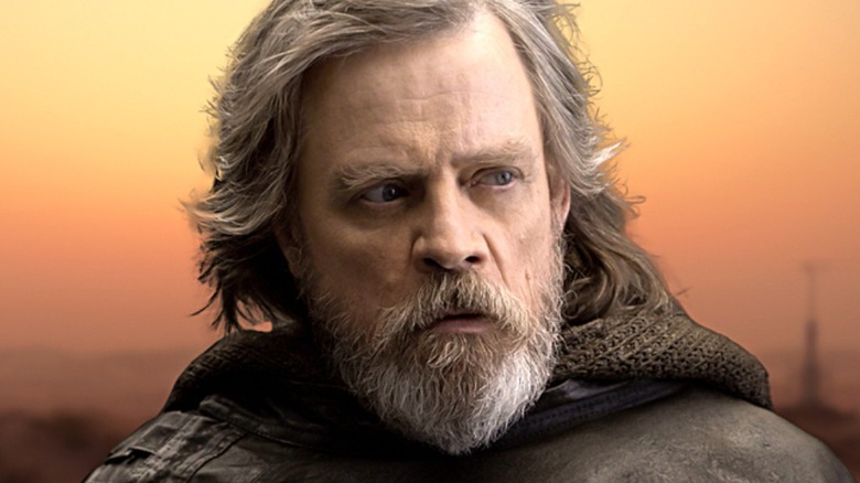 The older Luke Skywalker with an orange sky behind him