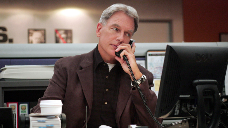 Leroy Jethro Gibbs using his phone at his desk on NCIS