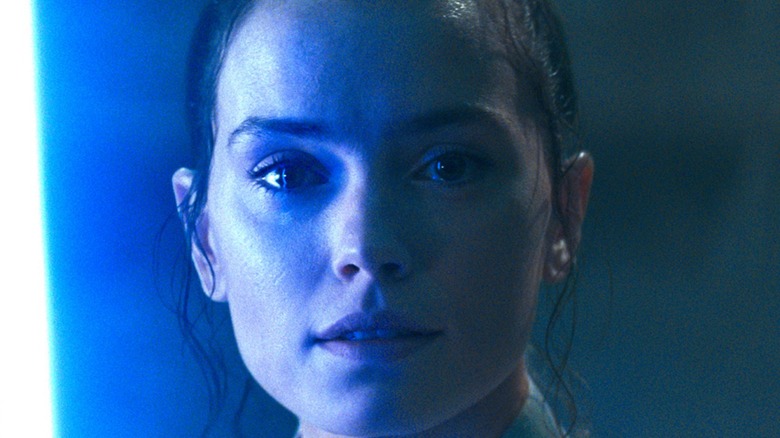 Rey lit by a lightsaber