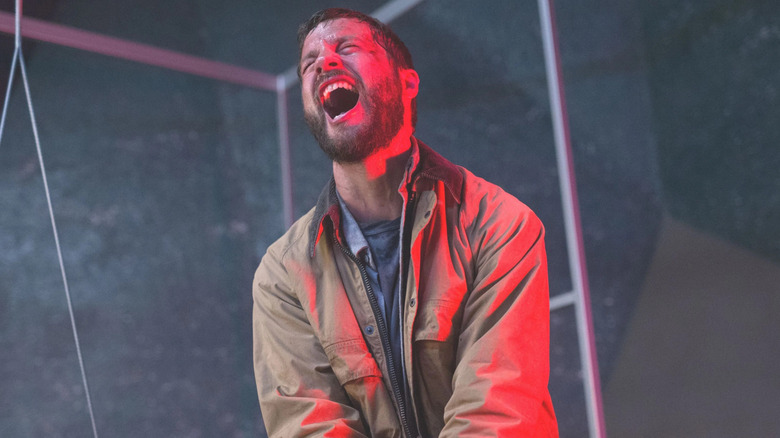 Grey yelling in red-lit room in Upgrade