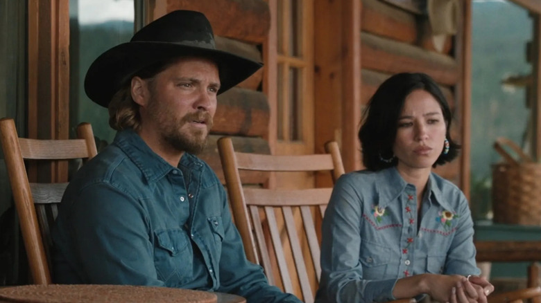 Kayce and Monica sit concerned on their porch in "Yellowstone"