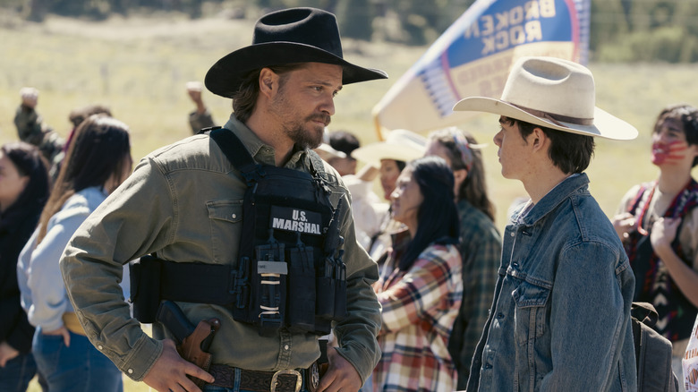 Tate and Kayce talking during the protest in "Marshals" (2026-)