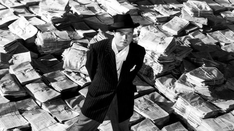 Charles Foster Kane standing in a pile of newspapers in "Citizen Kane" (1941)