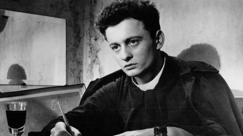 Curé d'Ambricourt looking up from his notes in "Diary of a Country Priest" (1951)
