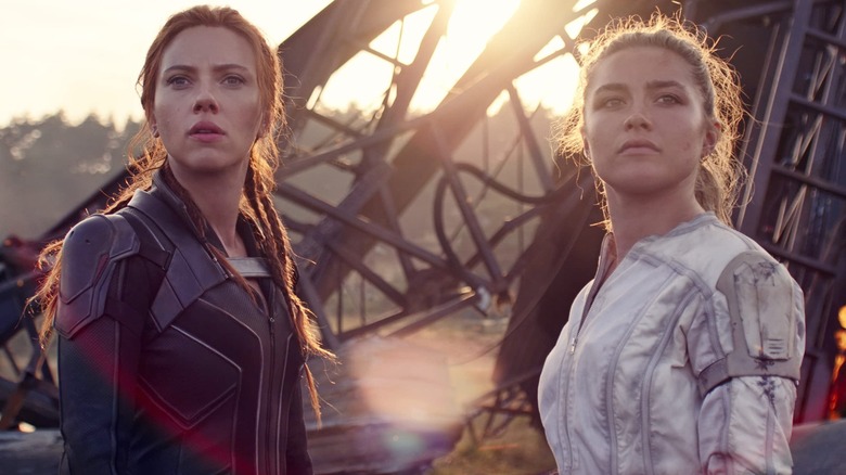Natasha in black and Yelena in white look into the distance in "Black Widow" (2021)