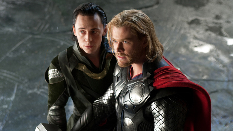 Thor and Loki looking up toward a threat in "Thor" (2011)