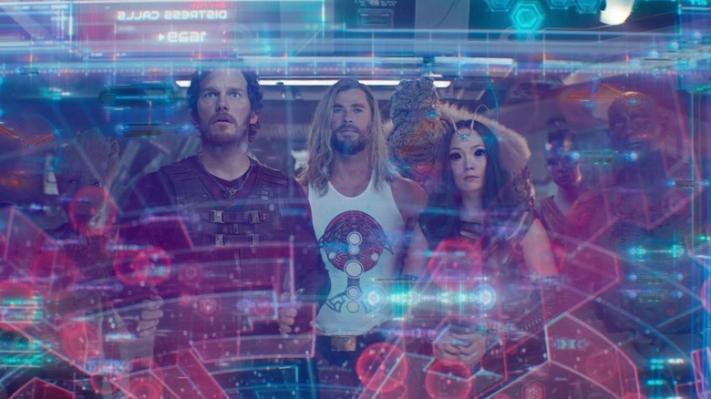 Thor, Korg, and the Guardians of the Galaxy inspecting a map in "Thor: Love and Thunder" (2022)