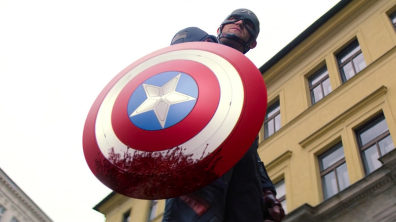 John Walker holding bloody shield
