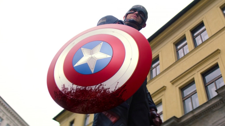 John Walker holding bloody shield