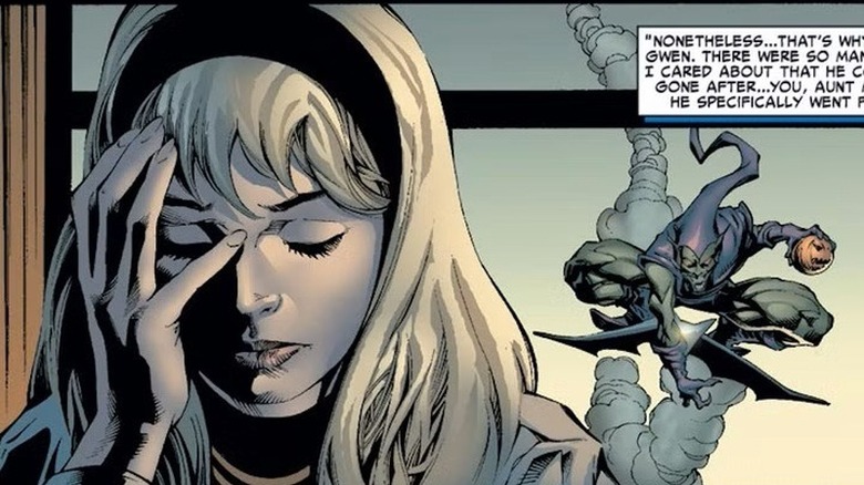 Gwen holds her face while Green Goblin flies in the background