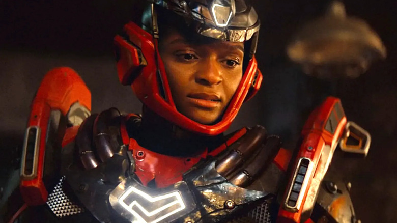 Riri Williams in her Ironheart suit looks concerned in Ironheart.
