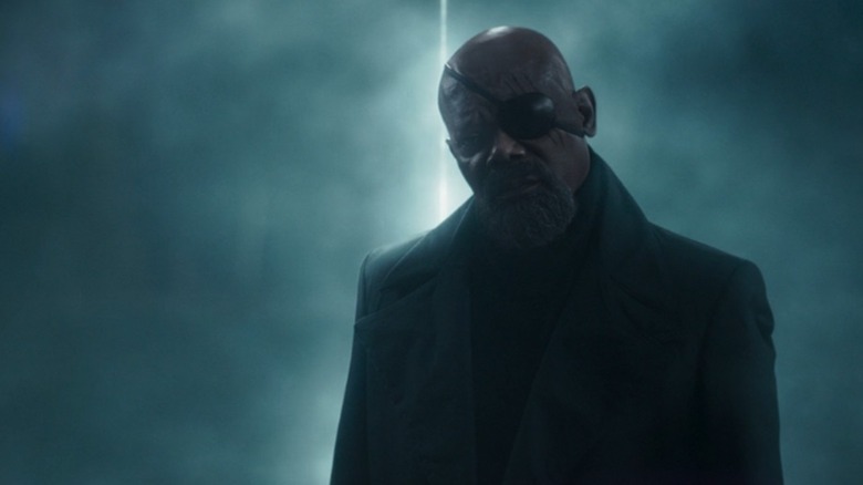 Nick Fury stands in front of an entrance beaming light behind him in Secret Invasion.