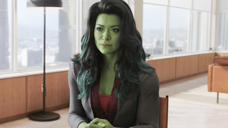 Jennifer Walters sits dressed in business casual in her Hulk state in She-Hulk: Attorney at Law