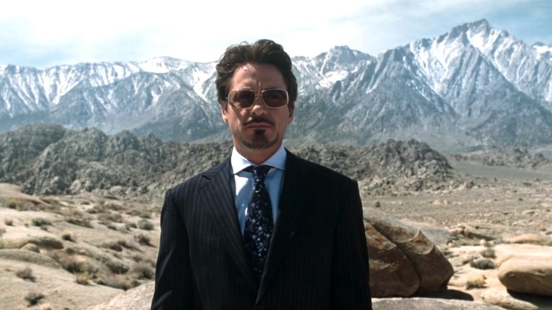 Tony Stark stands near mountain range