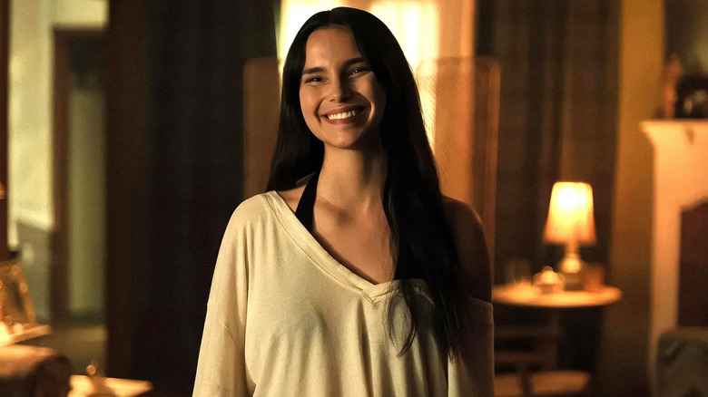 Nikki smiling widely in Obsession
