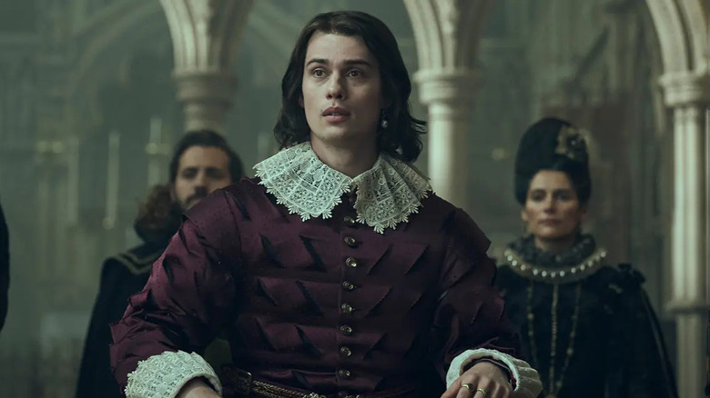 George appears in the royal court in formal dress in "Mary & George" (2024)