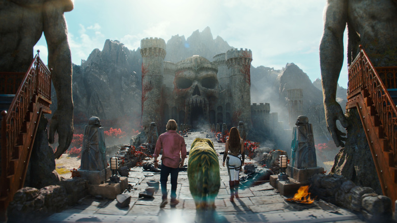 Adam, Teela, and Cringer walking to Castle Grayskull in Masters of the Universe
