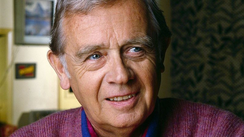 Warren Frost smiles, looks right