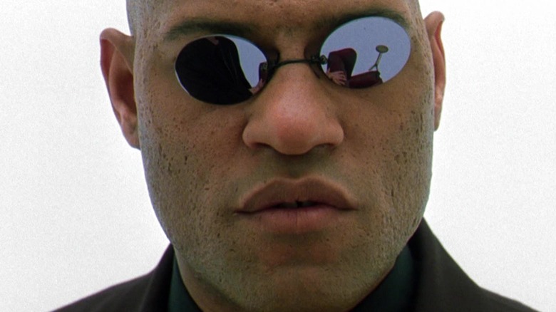 Morpheus wearing sunglasses in an all-white room