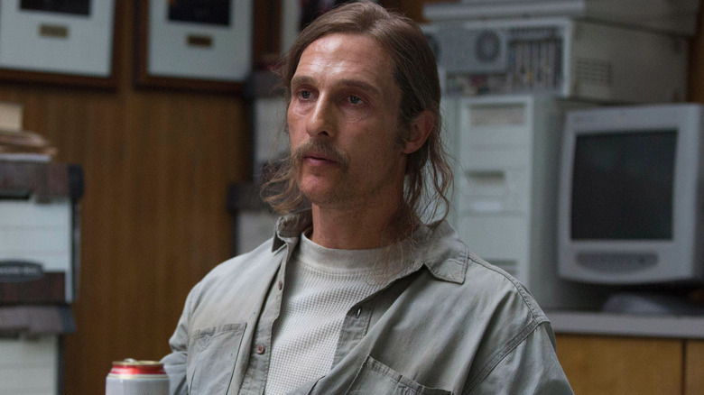 Rust Cohle sitting at a table