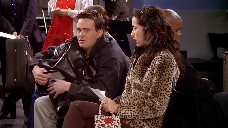 Chandler clutching bag in airport