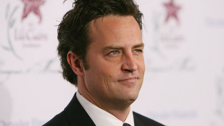 Matthew Perry wearing a suit and tie