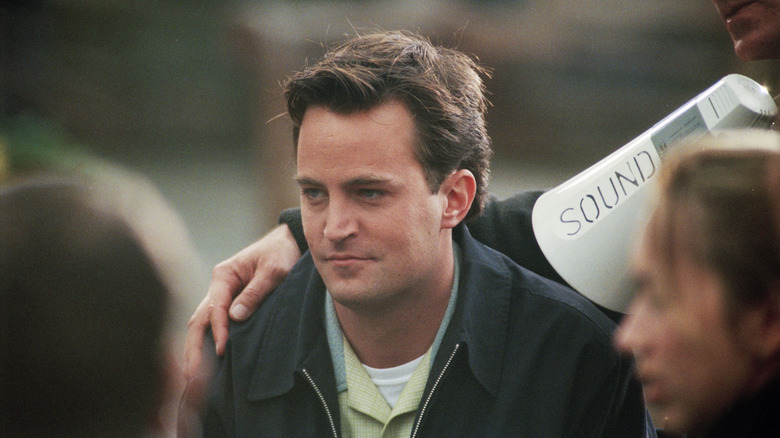 Matthew Perry with a hand draped around his shoulder