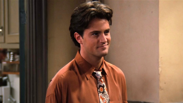 Chandler Bing smiling in hallway in "Friends" (1994)