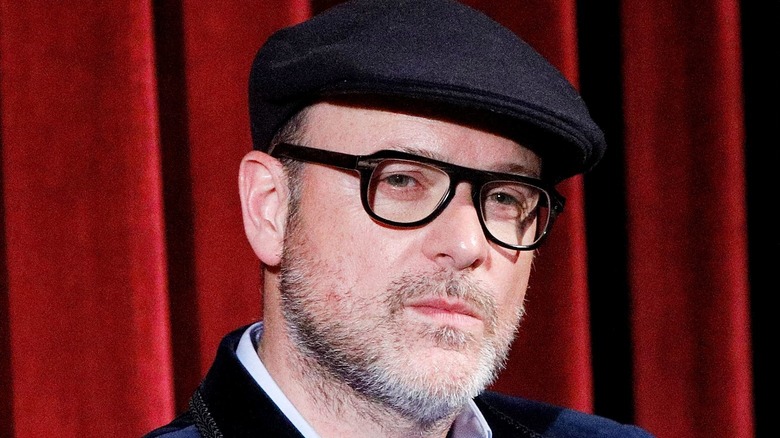 Matthew Vaughn wearing a hat and glasses and looking like a Kingsman