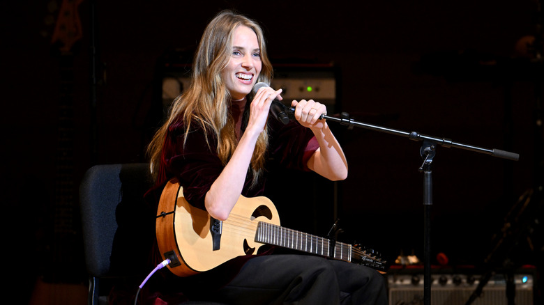 Maya Hawke performing onstage during the 39th Annual Tibet House US Benefit Concert