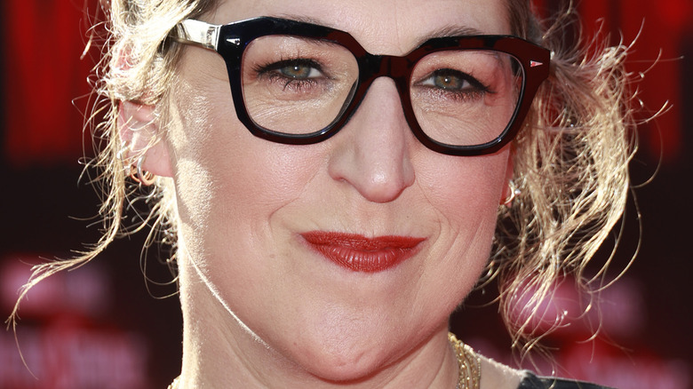 Mayim Bialik with red lipstick and glasses