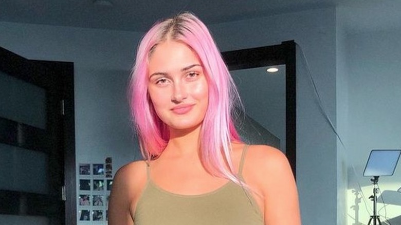 Hannah Ridgeway on bed pink hair