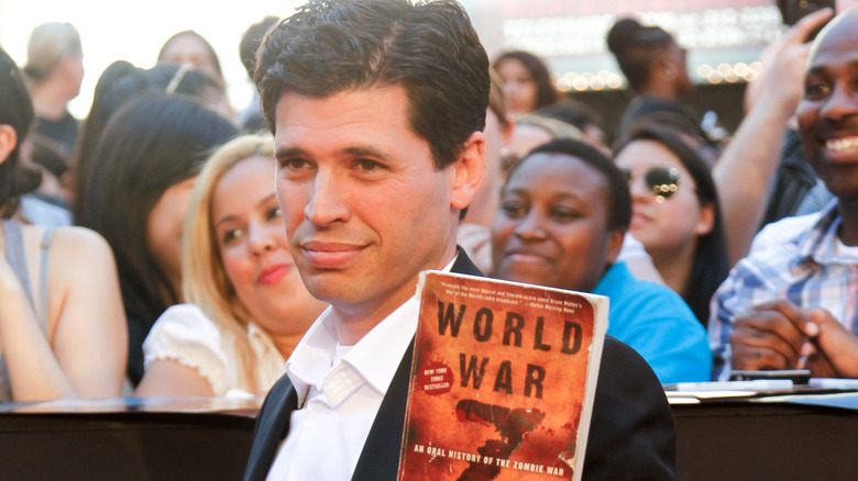 Max Brooks holds up book