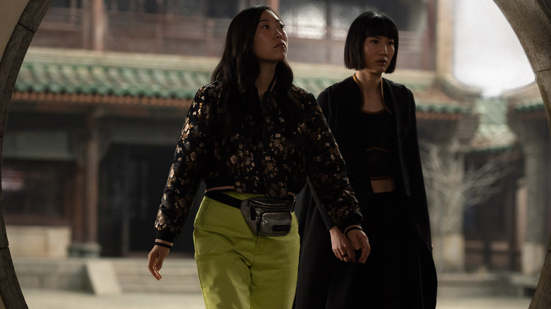 Katy and Xialing walk through doorway