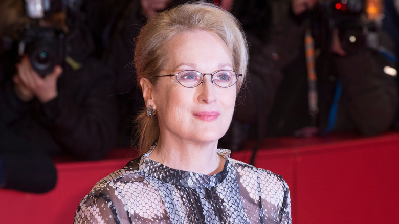 meryl streep on red carpet wearing glasses