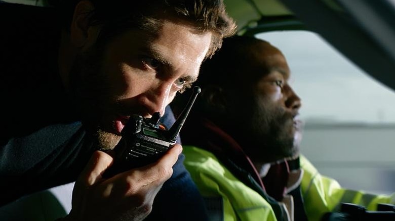 Danny talks into a walkie talkie while Will drives the ambulance in Ambulance