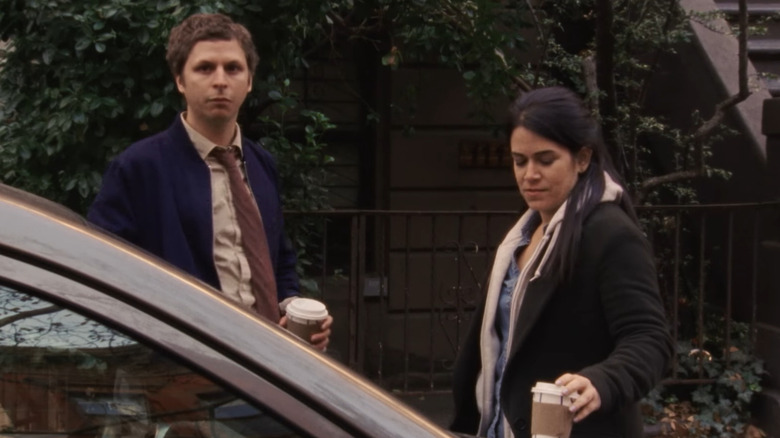 Michael Cera and Abbi Jacobsen stand next to a car