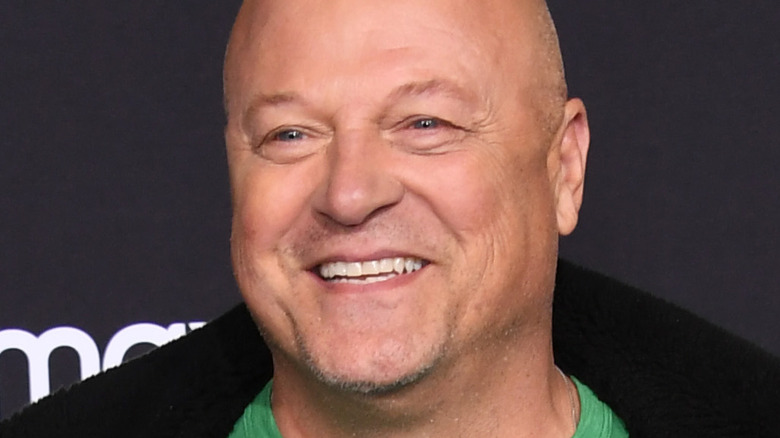 Michael Chiklis wearing green shirt and black jacket