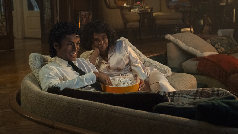 Michael Jackson and Katherine Jackson sitting on the couch with popcorn in "Michael" (2026)