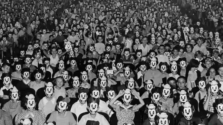 Crowd of people wearing Mickey Mouse masks