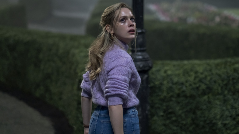 Dani looking over her shoulder scared in "The Haunting of Bly Manor"