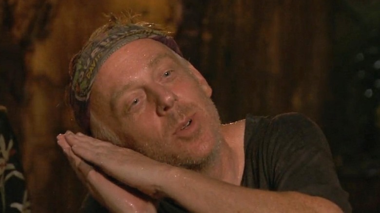 Mike miming a pillow with his hands on "Survivor."